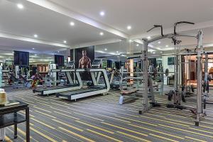 a gym with several tread machines in a room at Wyndham Garden Hoi An Cua Dai Beach in Hoi An