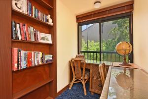 a room with a window and a desk and a chair at Kaanapali Royal D302 in Lahaina