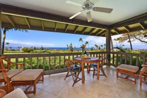a patio with a table and chairs on a balcony at Kaanapali Plantation 8 in Lahaina