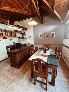 a kitchen with a table and chairs in a room at Casa Arrayanes Tempo in Esquel