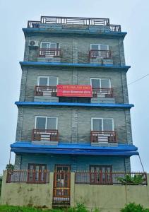 a tall building with windows and balconies on it at Hotel Himalayan Home Lamagaun Pokhara 10 minute drive from tourist place lakeside rent Rooms in Pokhara