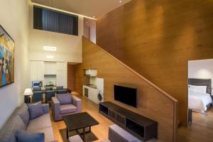 a living room with a staircase leading to a bedroom at The Westin Xi'an in Xi'an