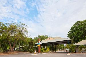 a gas station with a sign in a parking lot at RAC Cable Beach Holiday Park in Broome