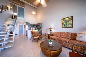 a living room with a couch and a table at Kulakane 306 in Kahana