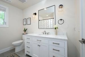 a white bathroom with a sink and a toilet at Luxury mountain oasis, hot tub & 15 mins to DT AVL in Juno +35 photos