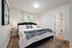 a bedroom with a large bed and a window at Luxury mountain oasis, hot tub & 15 mins to DT AVL in Juno
