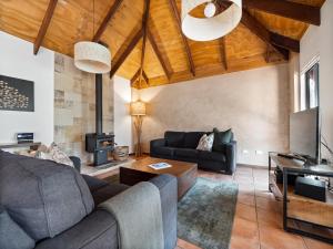 a living room with a couch and a stove at Forest Rise Chalets and Lodge in Metricup