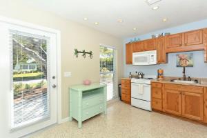 a kitchen with wooden cabinets and a sink and a stove at Minnow 2 Villa in Anna Maria