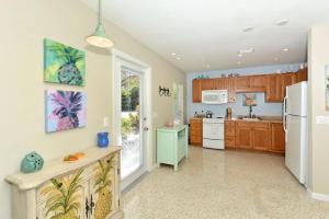 a kitchen with wooden cabinets and a white refrigerator at Minnow 2 Villa in Anna Maria