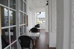 a dining room with a table and chairs at Luckswan Boutique Chiang Rai - SHA Extra Plus in Chiang Rai