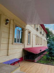 a balcony of a building with a red roof at Eurasia hotel in Almaty