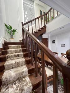 a wooden staircase in a house with a potted plant at Villa, Sea Front View منتجع قرية سما العريش in El Arish