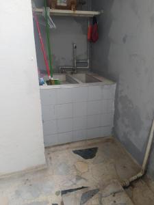baño con lavabo y suelo de baldosa. en Apartamento Villa Rocio, en Yopal