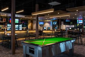 a pool table in a bar with tables and chairs at Morphett Arms Hotel in Adelaide