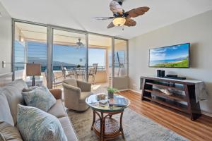 a living room with a couch and a table at Island Sands 210 in Maalaea
