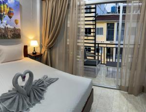 a bedroom with two swans decoration on a bed at S a f e Residence Patong in Patong Beach