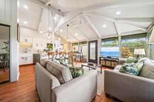a living room with two couches and a kitchen at International Colony Club 13 in Lahaina