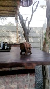 a wooden animal statue sitting on top of a wooden bench at Hotel Sol de Ocucaje in Ica