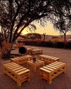 a group of wooden benches sitting in a park at Hotel Sol de Ocucaje in Ica