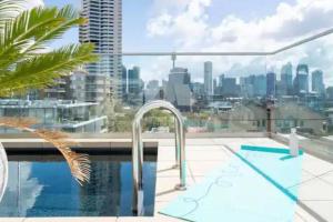 a swimming pool with a view of the city at Stunning Harbour Bridge and Opera House Views! in Sydney