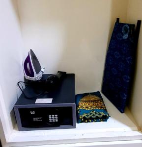 a microwave sitting on a shelf with a phone on it at PULANG RESORT in Setiu