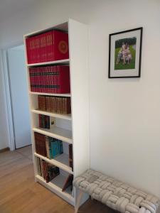 a book shelf with a bench in front of it at Gîte des Gônes - Lyon Charme in Feyzin