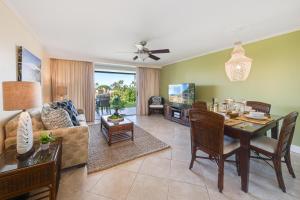 a dining room and living room with a table at Eldorado K103 in Kahana