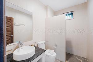 a white bathroom with a sink and a toilet at MyVillage Lamai in Lamai