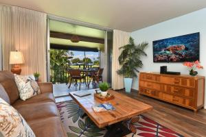 a living room with a couch and a table at Eldorado J218 in Kahana