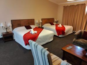 Voodi või voodid majutusasutuse Gateway Motor Inn toas