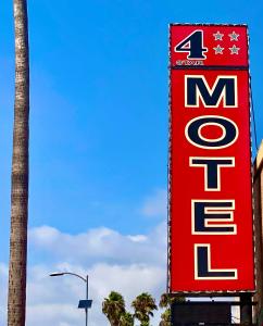 a large red sign for a fast food restaurant at 4 Star Motel in Los Angeles