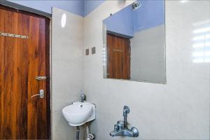 a bathroom with a sink and a mirror at FabExpress Westin Palaza in kolkata