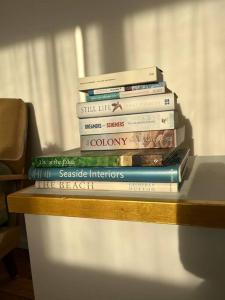 a stack of books sitting on top of a table at Sea Rest in Forster