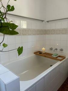 a bathroom with a bath tub with a candle in it at Sea Rest in Forster