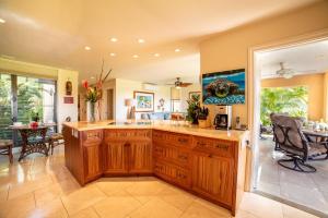 a kitchen with a large island in a room at Wailea Ekahi 32B in Wailea