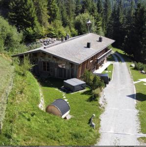 an aerial view of a house on a hill at Luxury old wood mountain chalet in a sunny secluded location with gym, sauna & whirlpool in Scheffau am Wilden Kaiser