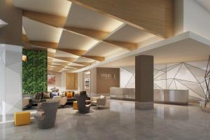 a lobby of a hotel with couches and chairs at The Westin Irving Convention Center at Las Colinas in Irving