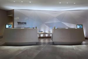 a lobby with two reception desks in a building at The Westin Irving Convention Center at Las Colinas in Irving