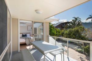 a balcony with a bed and a table and chairs at Bombora in Lennox Head