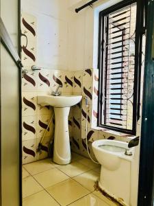 La salle de bains est pourvue d'un lavabo et de toilettes. dans l'établissement Thamel Hub Hostel, à Katmandou