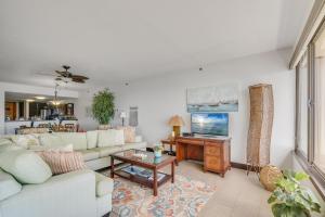 a living room with a couch and a table at Sands of Kahana 354 in Kahana