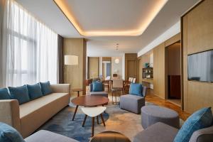 a living room with a couch and a table at The Westin Qingdao West Coast in Huangdao