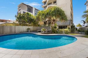 a swimming pool in front of a building at Surfside Court - Hosted by Burleigh Letting in Gold Coast
