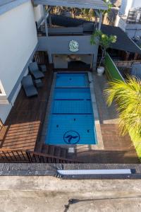 a small swimming pool on a deck with a house at Rabasta Enjoy Kuta in Denpasar