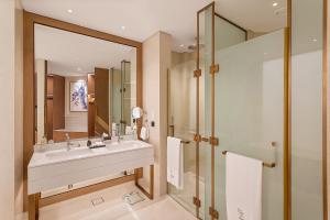 a bathroom with a sink and a shower at Ajman Hotel by Blazon Hotels in Ajman 