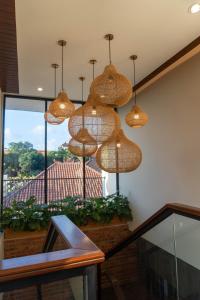 a group of lights hanging from a ceiling at Rabasta Enjoy Kuta in Denpasar