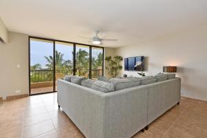 a large couch in a living room with a large window at Paki Maui 424 in Kahana