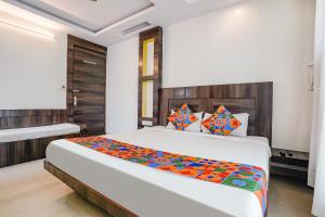 a bedroom with a large bed in a room at FabHotel Kingdom Sai in Shirdi