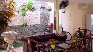 a living room with a couch and a stone wall at Zen Boutique Syariah Hotel in Jakarta