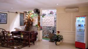 a room with a table and chairs and a refrigerator at Zen Boutique Syariah Hotel in Jakarta